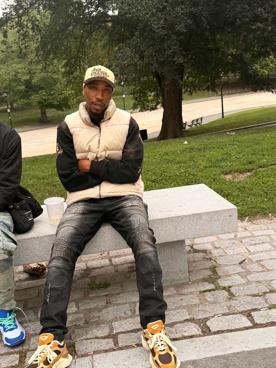 The Real Dnation seated on a park bench