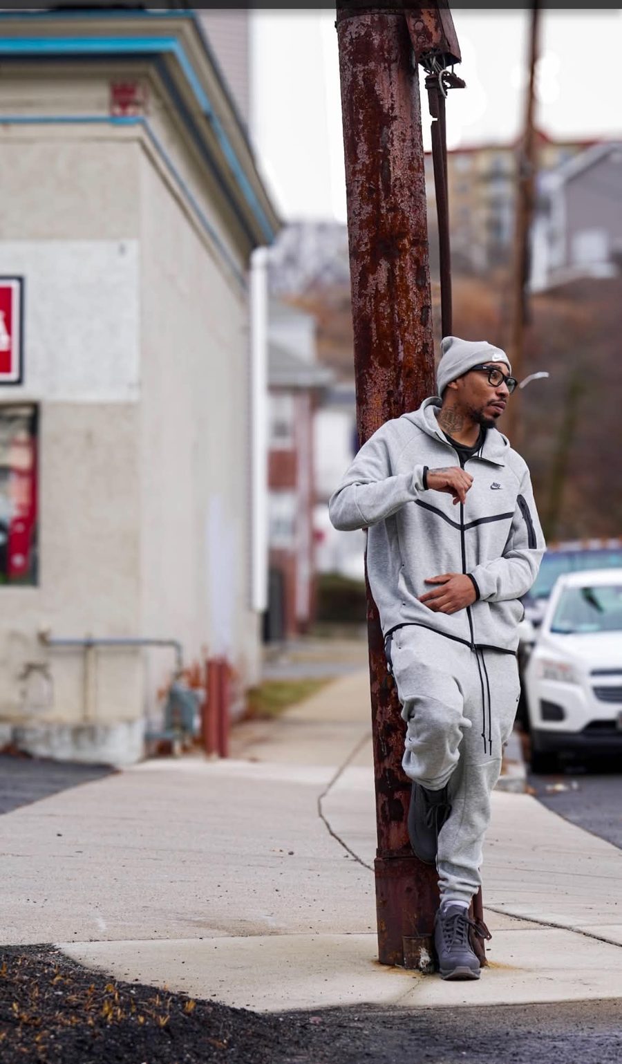 The Real Dnation in a gray tracksuit on a city street